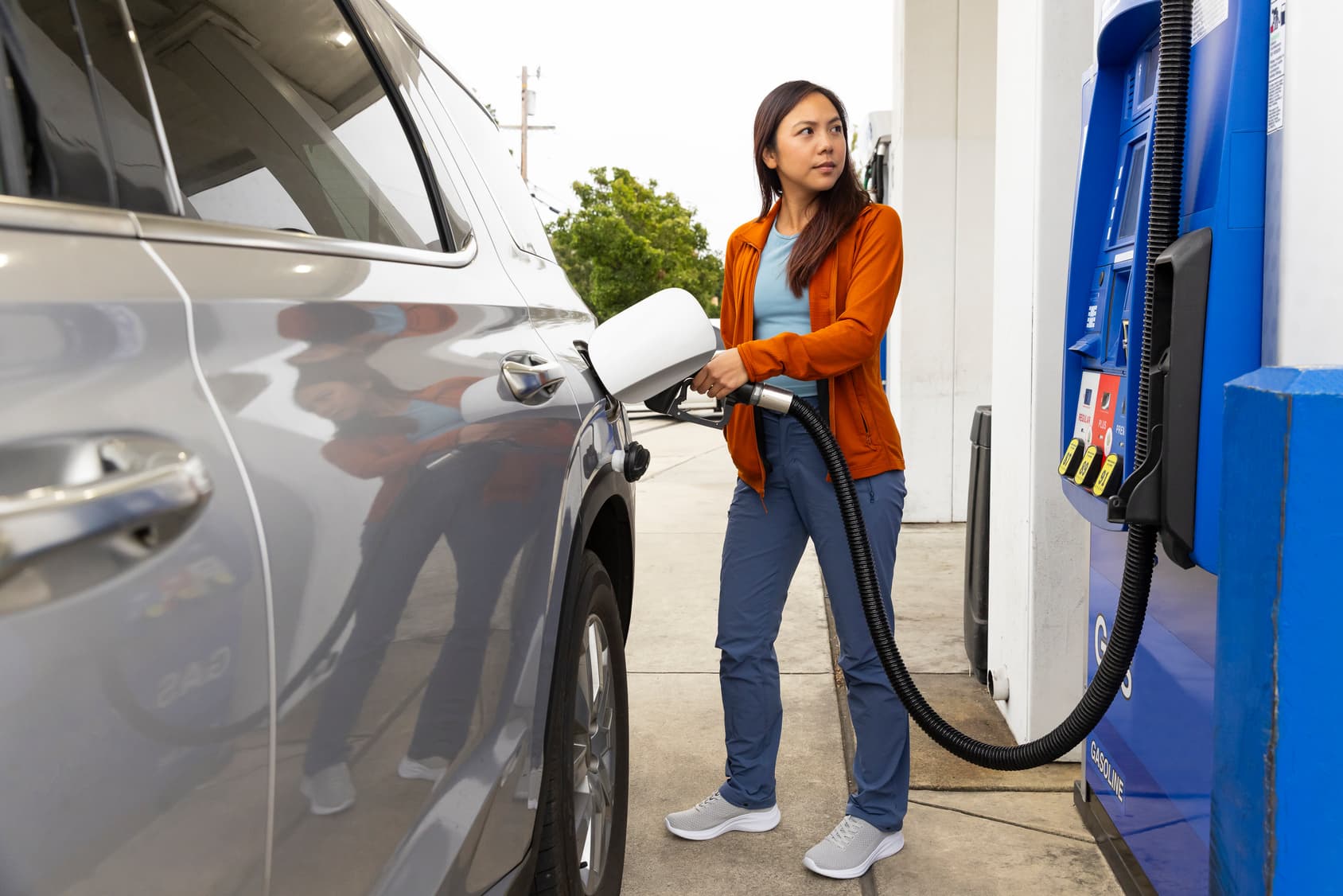 Driver filling up at a gas station